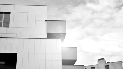 Part of city real estate property and condo architecture. Detail in modern residential flat apartment building exterior. Fragment of new luxury house. Black and white.