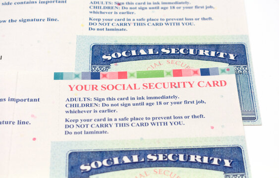 Selective focus. Two social security cards with an instructions how to sign and store government documents