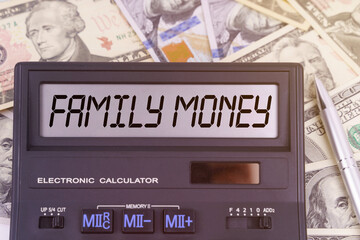 On the table are dollars and a calculator on the electronic board which says FAMILY MONEY