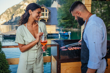 Happy couple grilling outdoors