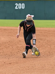 Girls in action playing in a softball game