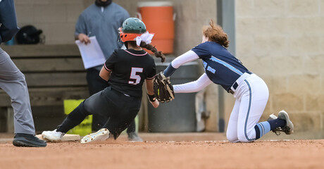 Girls in action playing in a softball game