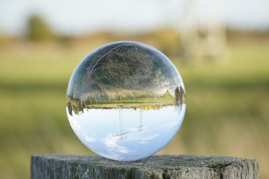 Electricity pylons in the lens ball  - Powered by Adobe