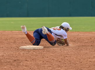 Girls in action playing in a softball game