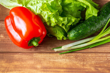 Set for making salad of fresh herbs, cucumbers and red pepper on a vintage table. Idea for a restaurant or cafe
