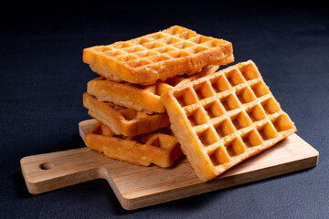 Sweet waffles prepared for serving. A tasty dessert eaten with fruit and preserves.