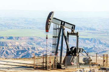 View of the pumpjack in the oil well. A pump jack is a device used in the petroleum industry to...