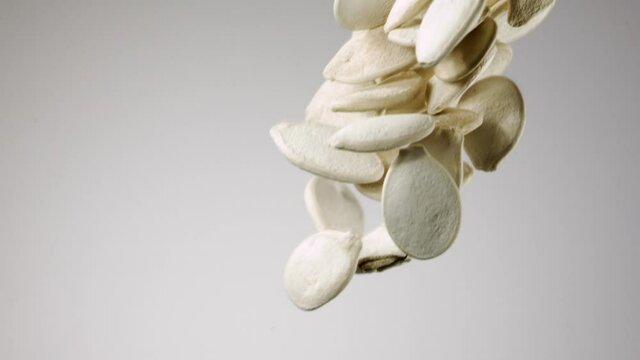 Beautiful pumpkin seeds falling in slow motion