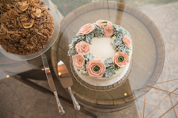 Rose decorated wedding cake on a wine barrel