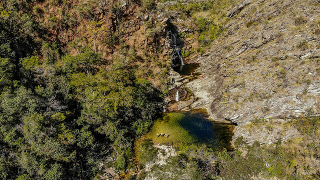 Huge waterfall view from above with drone with the river at the end in the middle of the forest in the center of Brazil. Serra do cip&oacute; - Minas Gerais