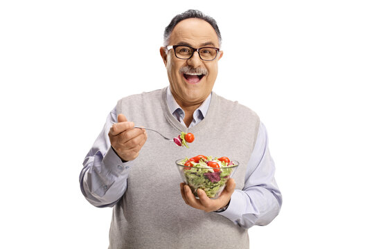 Happy Mature Man Standing And Eating A Salad