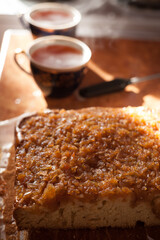 Freshly baked homemade apple pie with a mug of tea in the background.