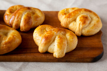 Homemade Basic Soft Pretzels on a rustic wooden board, side view. Close-up.