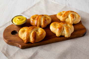 Homemade Basic Soft Pretzels with Mustard, low angle view.