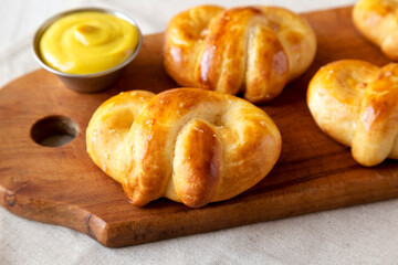 Homemade Basic Soft Pretzels with Mustard, side view. Close-up.