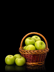 Fototapeta na wymiar Green apples in wattle basket