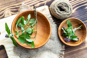 Prunella vulgaris, self-heal, carpenter's herb purple flower tincture with root on wooden...