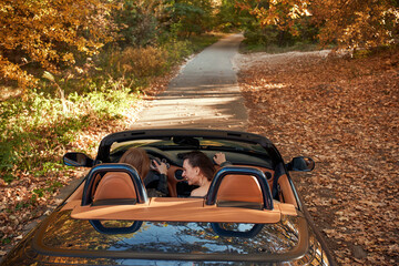 Rear view of two women friends in cabliolet