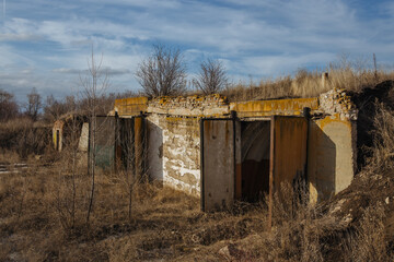 Fototapeta na wymiar Entrance to abandoned underground depot in Soviet military base