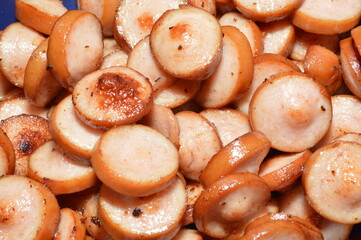 Sausages cut into pieces. Boiled sausage product. the process of cooking.