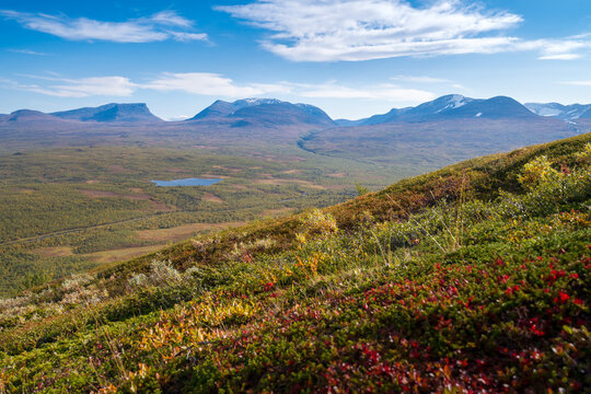 Lapponian gate, famous mountain pass in the Swedish arctic in beautiful autumn colors on a sunny day. Viewed from Nuolja, Njulla mountain. Hiking in Abisko national park, Kiruna, Sweden.