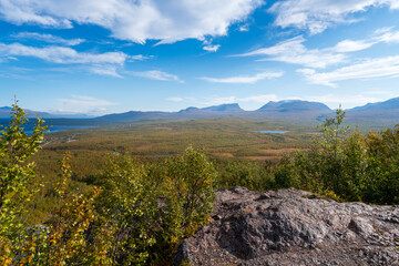 Lapponian gate, famous mountain pass in the Swedish arctic in beautiful autumn colors on a sunny day. Viewed from Nuolja, Njulla mountain. Hiking in Abisko national park, Kiruna, Sweden.