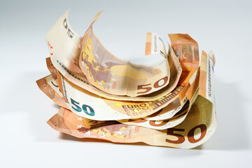 Crumpled 50 euro notes layered on top of each other in a pile, concept for finance and money...