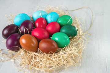 preparation for Easter, colorful eggs in a nest of straw