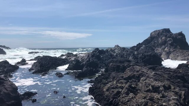 Waves of Pacific Ocean hitting shores near Pacific Rim National Park Reserve - popular surfing destination located between Tofino and Ucluelet on the west side of Vancouver Island 