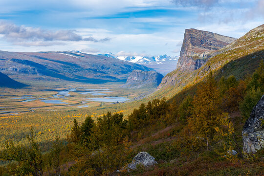 Wild, beautiful arctic landscape of northern Sweden. Skierfe mountain and Rapa river valley in early autumn. Sarek National Park. Sunny day in remote wilderness. Colors of autumn in the arctic.