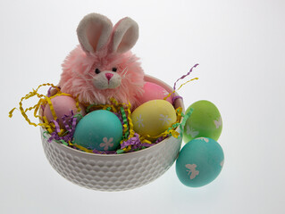 Easter themed still life with pink plush bunny and hand dyed easter eggs.
