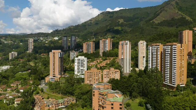Drone Descends in Poblado, Medellin, Colombia with Beautiful Landscape of Andes Mountains in Background