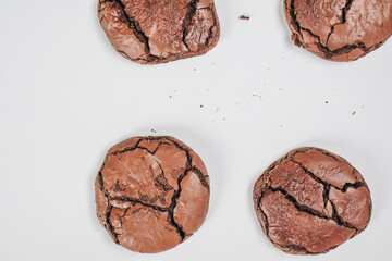 Chocolate brownie cookies. Baked Creamy Dark chocolate chip cookies on white texture background. Morning table. Copy space.