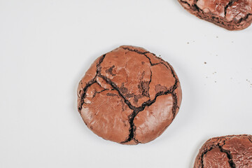 Chocolate brownie cookies. Baked Creamy Dark chocolate chip cookies on white texture background. Morning table. Copy space.