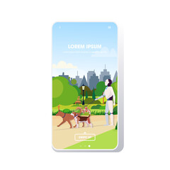 Naklejka premium modern robot walking with dogs artificial intelligence technology concept public park cityscape background smartphone screen mobile app copy space full length