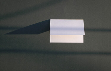 Empty white card with shadows on black background.