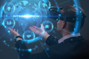 Business, Technology, Internet and network concept. Young businessman working on a virtual screen of the future and sees the inscription: Introduction