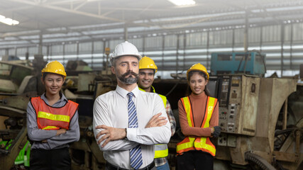 Group of factory workers or engineers express a great confident with arm crossed after big business...
