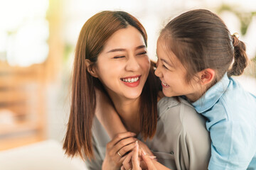Happy mother and little girl daughter having fun at home