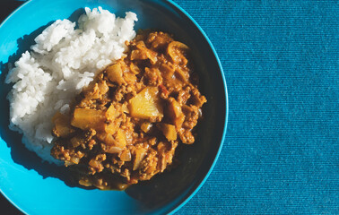 Pineapple curry on a blue luncheon mat.
