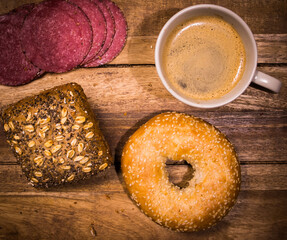 Breakfast table with rolls, coffee and sausage - top down view - food photography