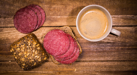 Breakfast table with rolls, coffee and sausage - top down view - food photography