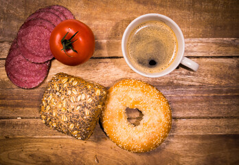 Breakfast table with rolls, coffee and sausage - top down view - food photography