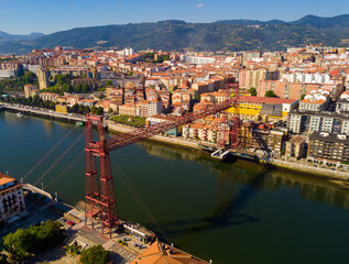 Fototapeta na wymiar Aerial view of Vizcaya bridge over the river and cityscape at Portugalete, Spain