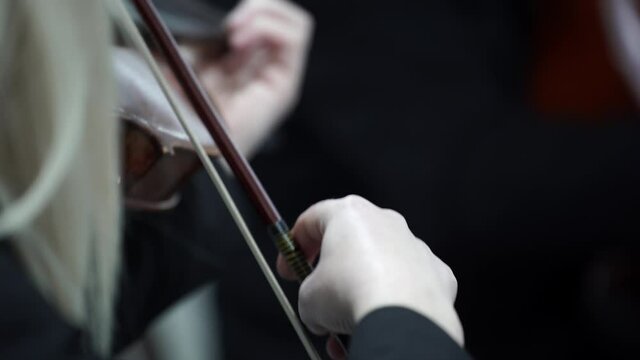 Classical music played by female violinist on symphony orchestra