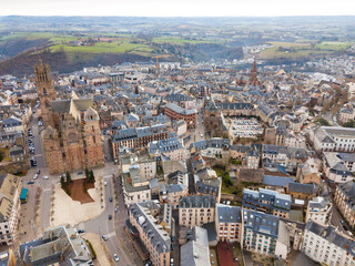 Obraz premium Aerial view of French city of Rodez with tower of Cathedral and spire of church of Saint Amans in autumn day