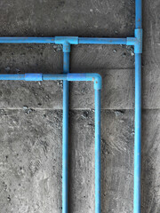 Blue PVC Piping System of Water on the concrete floor in construction site of building with copy space