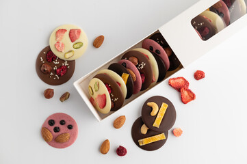 a set of handmade chocolate with dried fruits, nuts, mediants, congratulatory packaging