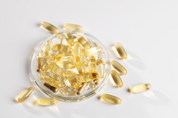 set of vitamin D, omega 3-6-9, zinc, yellow capsules on a white background