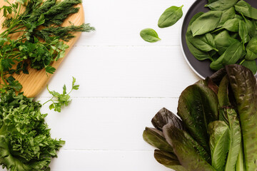 Bowl with salad leaves of spinach, lettuce, romaine, parsley, white background